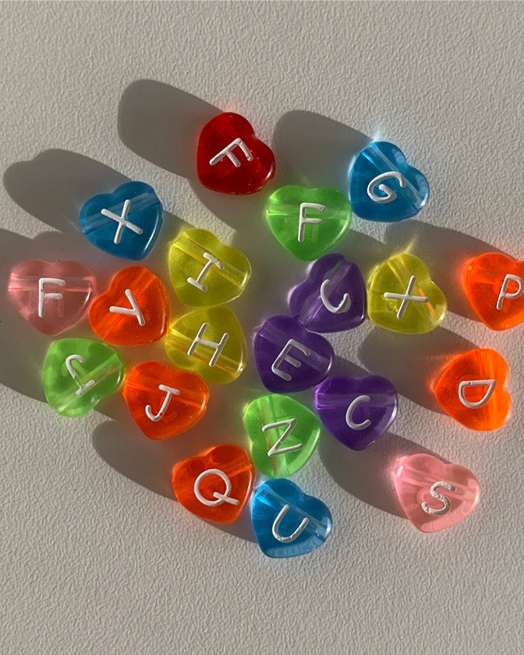 Assorted colourful heart shaped alphabet beads to choose from when creating a Buttercup Studio Dream Custom Bracelet.