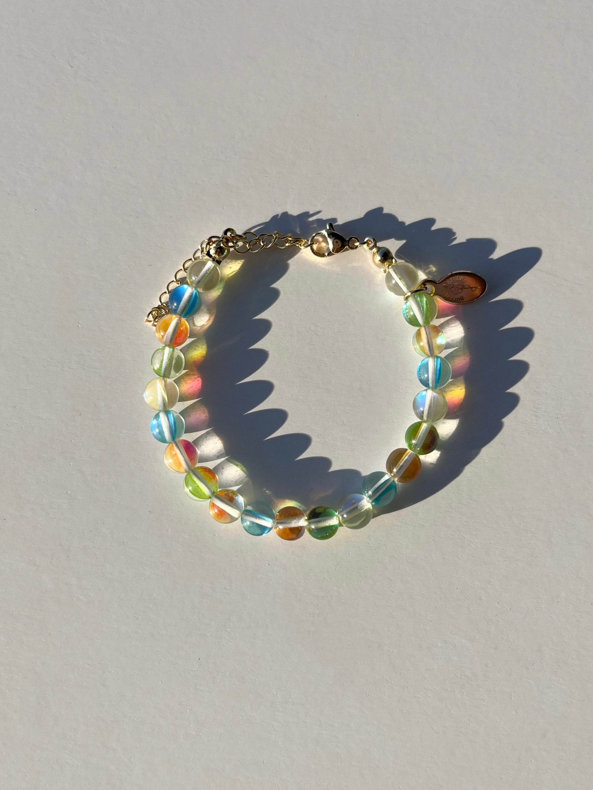 A studio shot of Buttercup Studio's Tropical Bubbly Bubbles Bracelet. Made with assorted colourful glass beads. 