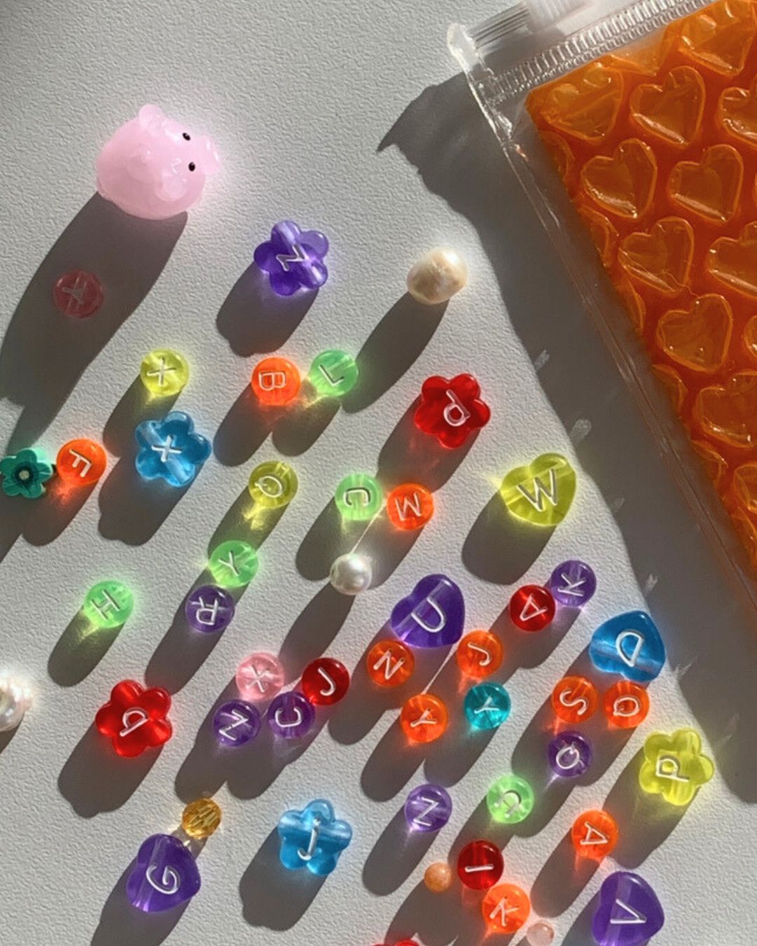 Assorted colourful alphabet beads to choose from when creating a Buttercup Studio Custom Multi Colour Bracelet.