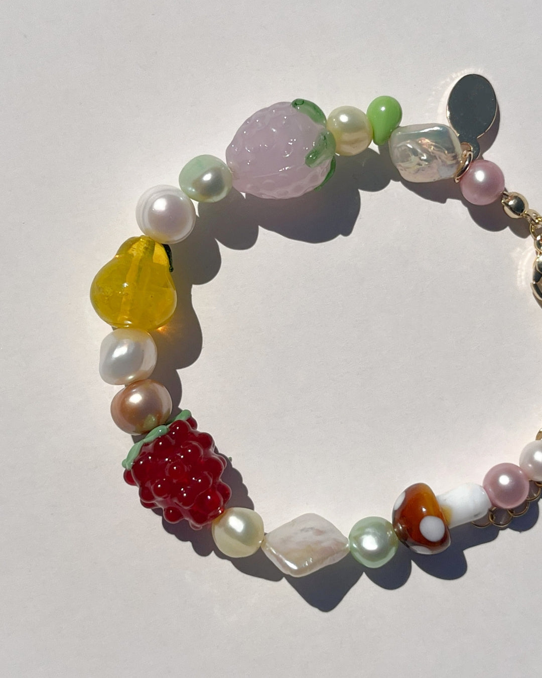 Whether you're headed to a picnic or a sunny day out, The Farmers Market Freshwater Pearls Bracelet adds a splash of fruity fun to any occasion. The Farmers Market Freshwater Pearls Bracelet is made using high-quality AA+ rare freshwater pearls and glass fruit beads. Finished with 14k gold clasps and an adjustable chain. Perfect for stacking with The Picnic Blanket Freshwater Pearls Bracelet.&nbsp;