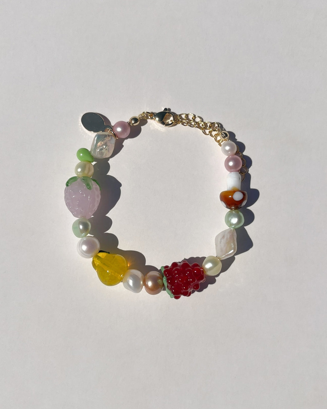 Whether you're headed to a picnic or a sunny day out, The Farmers Market Freshwater Pearls Bracelet adds a splash of fruity fun to any occasion. The Farmers Market Freshwater Pearls Bracelet is made using high-quality AA+ rare freshwater pearls and glass fruit beads. Finished with 14k gold clasps and an adjustable chain. Perfect for stacking with The Picnic Blanket Freshwater Pearls Bracelet.&nbsp;