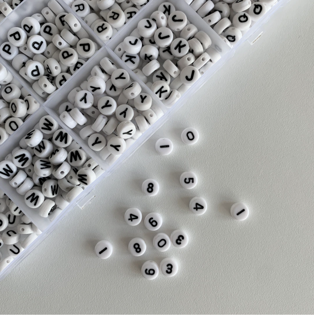 Assorted black and white circle alphabet and number beads by Buttercup Studio. 